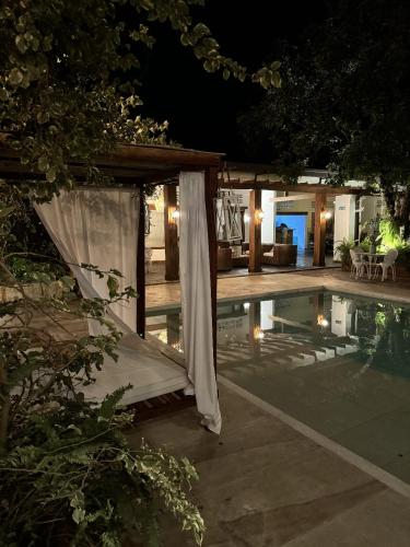 a house with a swimming pool at night at casa lumka hotel boutique spa in Mariquita