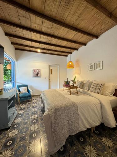 a large bedroom with two beds and a couch at casa lumka hotel boutique spa in Mariquita