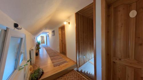 a hallway of a house with a wooden door at Simon House in Şimon
