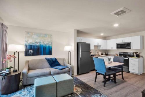 a living room with a couch and a table at WaterWalk Extended Stay Raleigh Durham Research Triangle in Durham