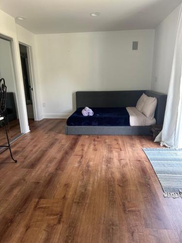 a bedroom with a bed and a wooden floor at Unique guest house loft in Spring Lake