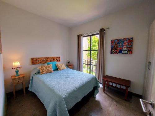 a bedroom with a blue bed and a window at Casa Kora by Avelia in San Miguel de Allende