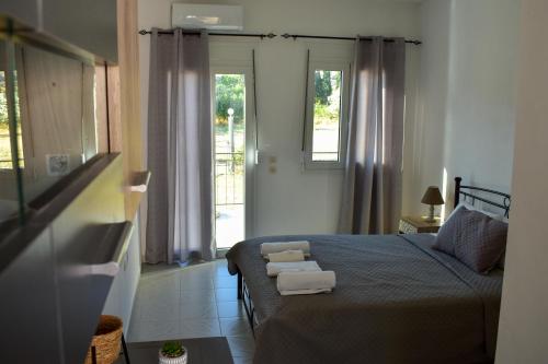 a bedroom with a bed with towels on it at Chliara apartments by Tzalas in Skala Eresou