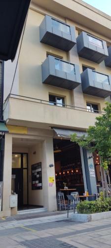 a building with balconies on the side of it at Theater apartment in Larisa