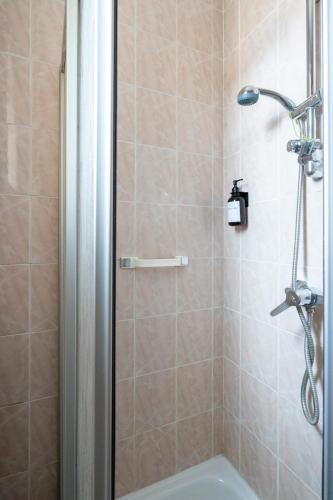 a bathroom with a shower with a toilet and a sink at Leoben Comfort Lodge Anytime Check In for Business and Family in Leoben