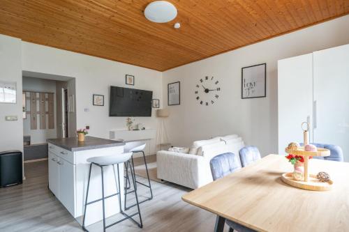 a kitchen and living room with a table and a tv at Leoben Comfort Lodge Anytime Check In for Business and Family in Leoben