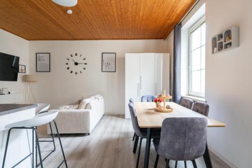a dining room and living room with a table and chairs at Leoben Comfort Lodge Anytime Check In for Business and Family in Leoben