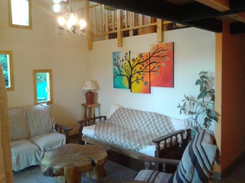 a living room with a couch and a table at Cabañas Orillas del Chimehuín in Junín de los Andes