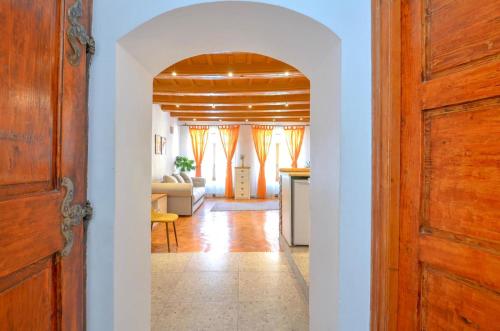 a hallway with a door and a living room at Charming Apartment - Heart of Brașov Poarta Schei in Braşov