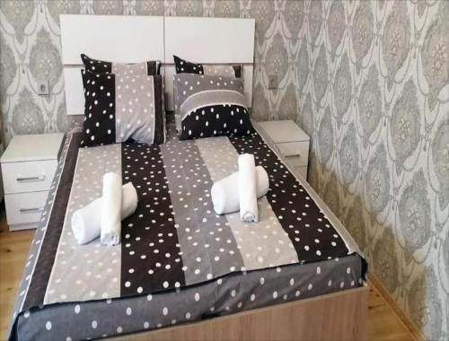 a bedroom with a black and white bed with polka dots at Eldeniz Nuxa House in Sheki