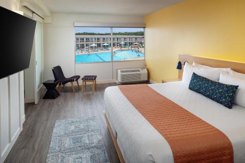 a hotel room with a large bed and a pool at Harbor Hotel Provincetown in Provincetown