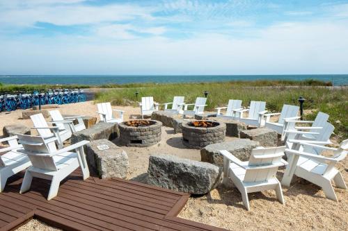a group of chairs and fire pits on the beach at Harbor Hotel Provincetown in Provincetown