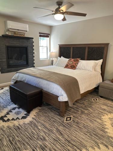 a bedroom with a large bed and a ceiling fan at YoBee! Park Reservation Included! Heart of Yosemite - Homey Studios and Breakfast in Yosemite West