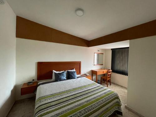 Postel nebo postele na pokoji v ubytování Hotel Pastora