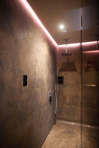 a bathroom with a shower with a glass door at Suite elegance Scheveningen in The Hague