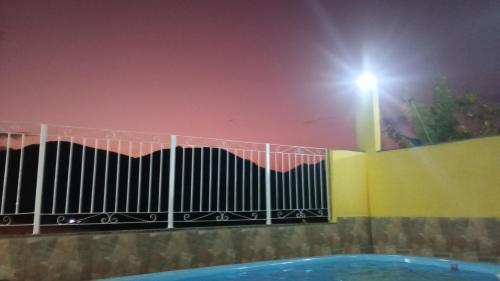 a light on top of a fence next to a pool at Pousada Preludio in Conservatória
