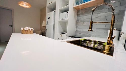 a kitchen with a sink and a counter top at D'Blue Búzios Hotel Boutique in Búzios