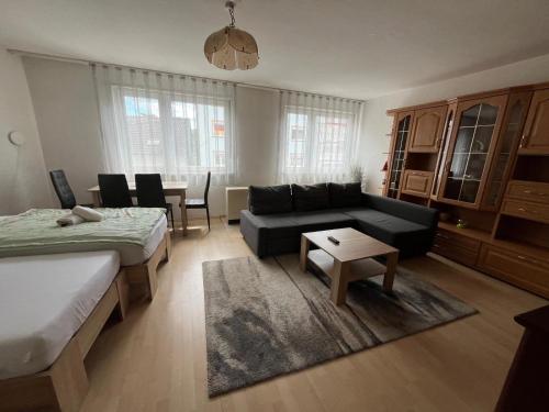 a living room with a couch and a table at Schöne Ferienwohnung in Saarbrücken in Saarbrücken