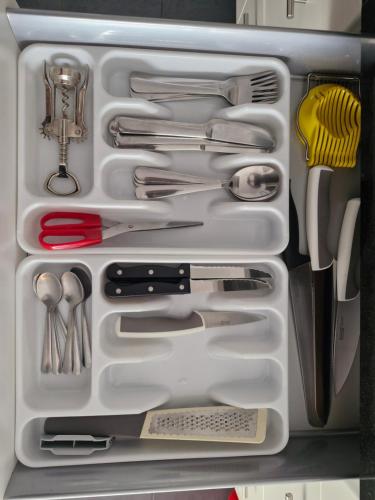a white drawer filled with lots of kitchen utensils at Torres del Sol 11th floor Atlantic view - Las Americas in Playa de las Americas