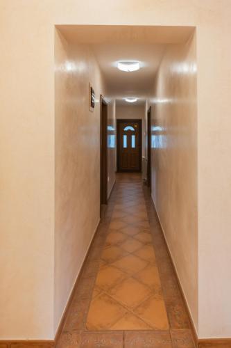 an empty hallway in a building with a door at Villa Botanicus in Petrovac na Moru