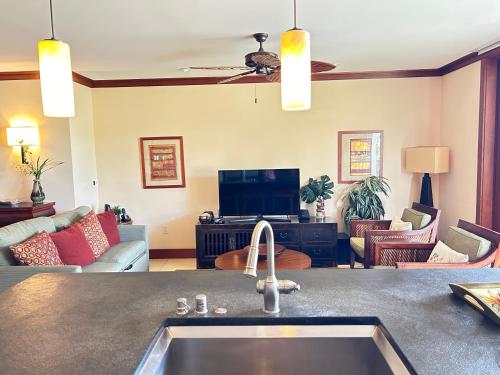 a kitchen with a sink and a living room at Luxury 2BR 2BA Ko Olina Beach Villa O410- Sleeps 6 Steps to Lagoon & Aulani in Kapolei
