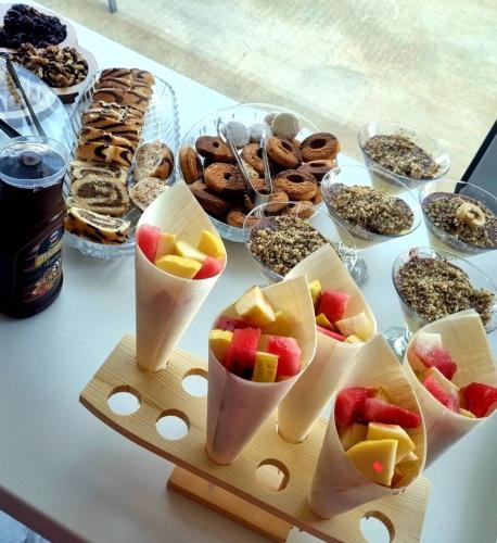 a table with a bunch of different types of food at Sunrise Apart-Hotel in Ulcinj