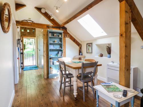 a kitchen and dining room with a table and chairs at The Ivy Barn in Hognaston