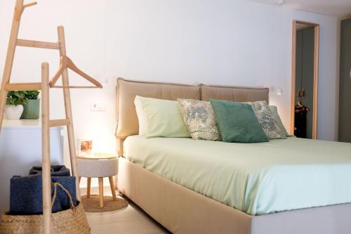 a bed with pillows and a ladder in a room at Il Nido di Nenna Apartment in Meta