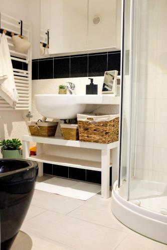 a bathroom with a white sink and a shower at Il Nido di Nenna Apartment in Meta