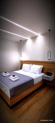 a bedroom with a large bed with two towels on it at Holy Sea Smart Suites in Elafonisi