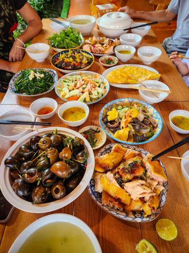 a table with many plates of food on it at Trang An Village Homestay in Ninh Binh