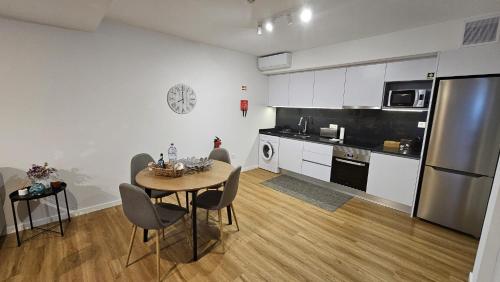 a kitchen with a table and chairs in a room at Magnólia Residence in Funchal
