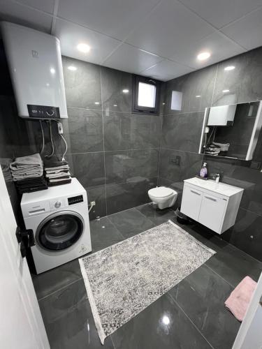 a bathroom with a washing machine and a sink at Villa Yakışıklı Bodrum vue mer avec piscine privée in Milas