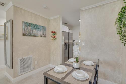 a dining room with a table and two chairs at Miami Gardens Apt 5 Miles to Hard Rock Stadium in Miami Gardens