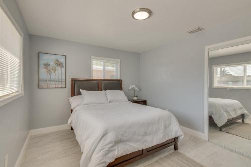 a white bedroom with a large bed and a window at Miami Gardens Apt 5 Miles to Hard Rock Stadium in Miami Gardens