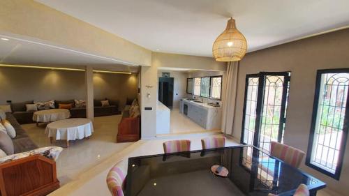 a large living room with a couch and a pool table at Ferme ADAM Agafay Marrakech in Marrakech