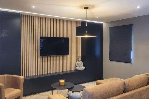 TV a/nebo společenská místnost v ubytování Maison T