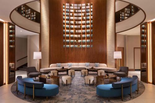 a hotel lobby with a table and chairs at Sheraton Grand Warsaw in Warsaw