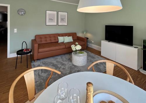 a living room with a couch and a table at neues trendy Appartement in Hannover in Hannover