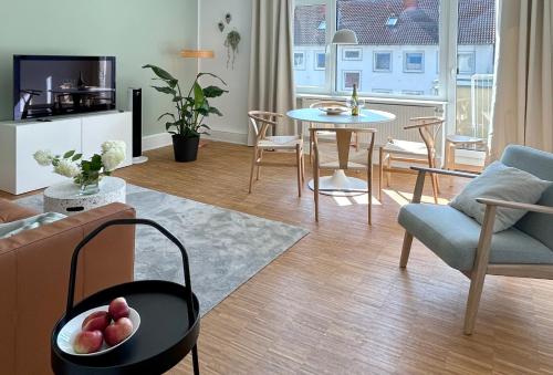 a living room with a couch and a table at neues trendy Appartement in Hannover in Hannover