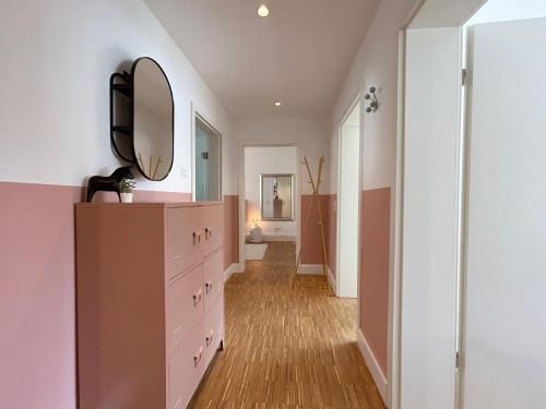 a hallway with a dresser and a mirror at neues trendy Appartement in Hannover in Hannover