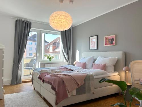 a bedroom with a bed and a large window at neues trendy Appartement in Hannover in Hannover