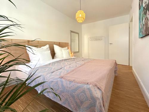 a bedroom with a bed and a potted plant at neues trendy Appartement in Hannover in Hannover