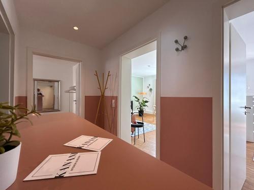 an office with a wooden table and a hallway at neues trendy Appartement in Hannover in Hannover