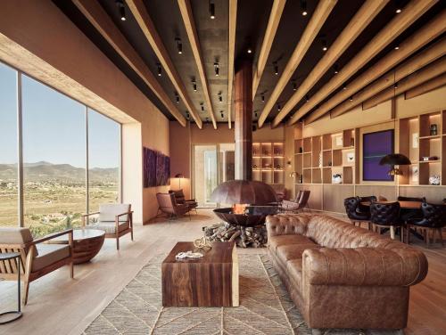 a living room with a couch and a fireplace at Banyan Tree Veya, Valle de Guadalupe - A Wellbeing & Wine Resort in Valle de Guadalupe