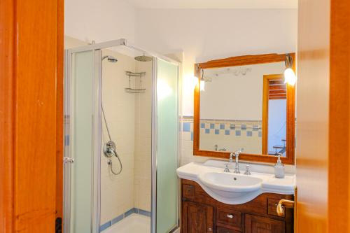 a bathroom with a sink and a shower at ALBACHIARA by CefaLux in Cefalù