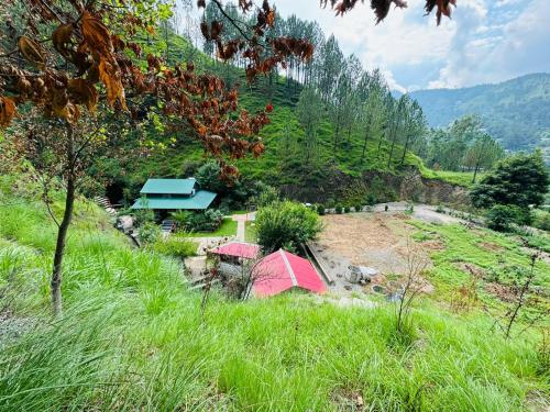 a group of tents in a grassy field at Hidden Resort Abbottabad in Abbottabad