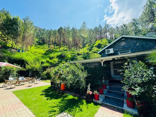 a house with a garden and a patio at Hidden Resort Abbottabad in Abbottabad