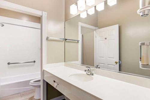 a bathroom with a sink and a toilet and a mirror at Best Western China Lake Inn in Ridgecrest