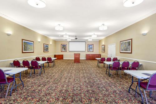 a conference room with tables and chairs and a whiteboard at Best Western China Lake Inn in Ridgecrest